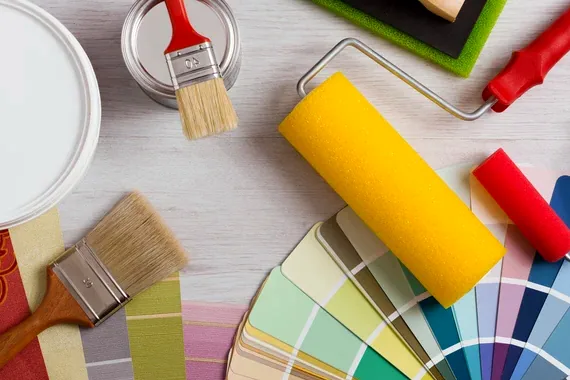 Brushes, rollers and color swatches laid out before a job